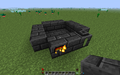 Step 2 Part 2: The second layer of the Smeltery is completed. Note that the Smeltery Controller is burning and the 3x3 space in the middle remains intact.